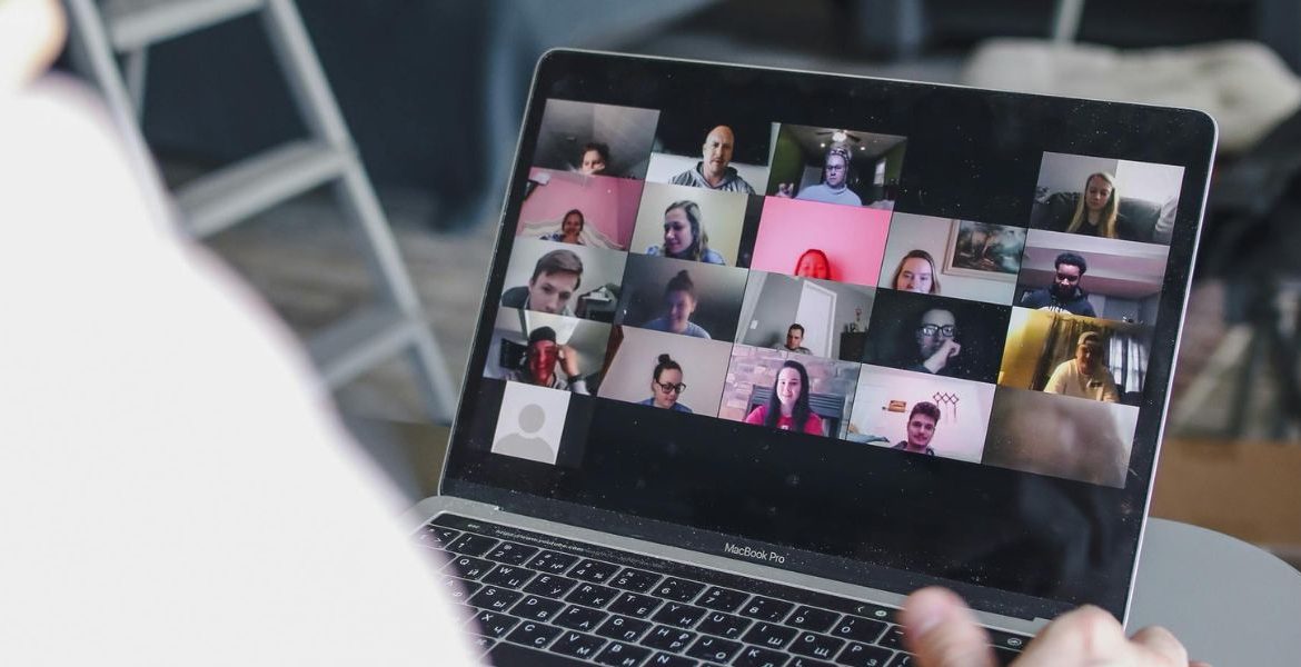 Remote team collaborating via video conferencing, showcasing the flexibility and efficiency of a business VoIP provider.