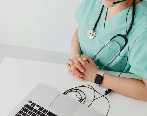 voip and iot integration use cases health care worker using voip on laptop while working.