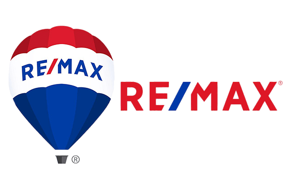 The RE/MAX logo. On the left is a hot air balloon with red and white stripes on top and blue on the bottom, with "RE/MAX" written across it in blue and white. To the right, "RE/MAX" is written again in a dark red color, with the "E/" in blue, and a red vertical bar next to it. The logo is on a white or transparent background.